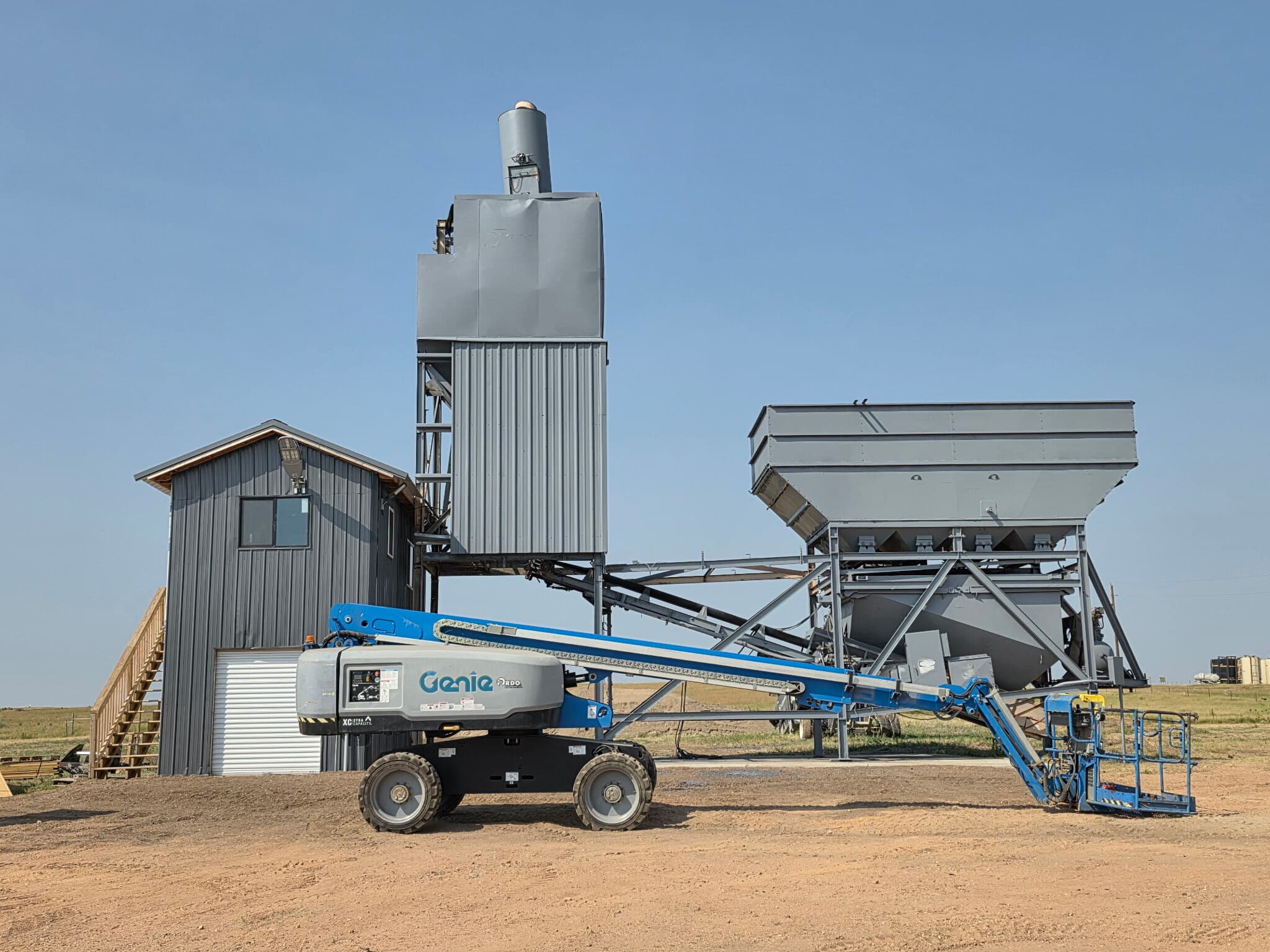 The batch plant at the yard, with bins, silo and charging conveyor